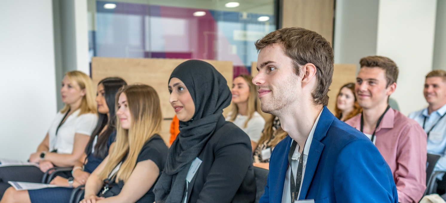 Graduates smiling in a group meeting